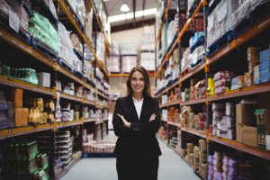 Businesswoman standing in the midst of a warehouse