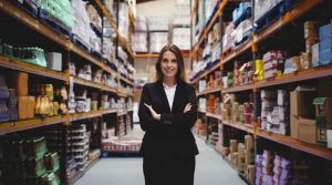 Businesswoman standing in the midst of a warehouse
