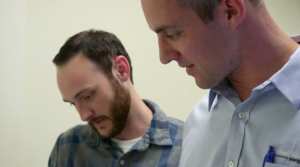 Jeremy Konkle looking over blueprints with a colleague