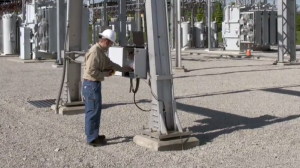 Travis Holton at work on a substation