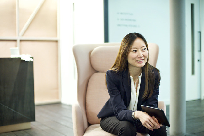 Business woman leaning forward in a chair