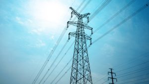 Electric towers against a bright blue sky