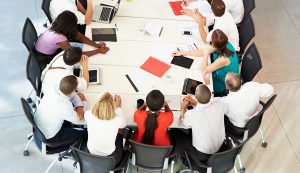 Employees gathered around a conference table