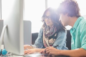 Students work together on a shared computer