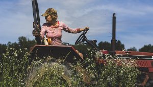 A woman backing up a tractor