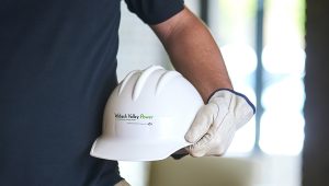 An employee holding a Wabash Valley Power hardhat