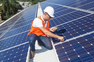 Man fixing solar panels