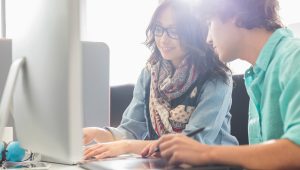 Two students working on a shared computer