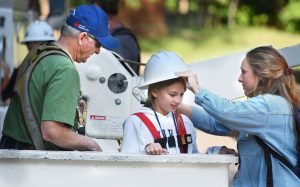 Camp attendee in bucket truck.