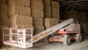 Image of equipment in front of hay bales.