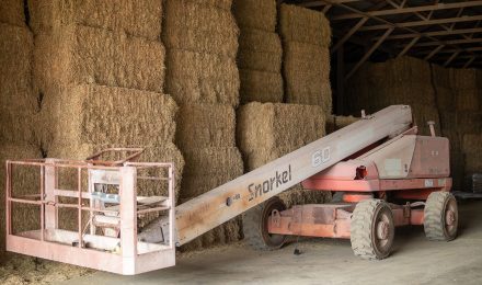 Image of equipment in front of hay bales.