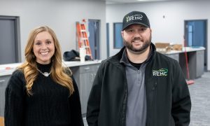 Two people standing in new office space